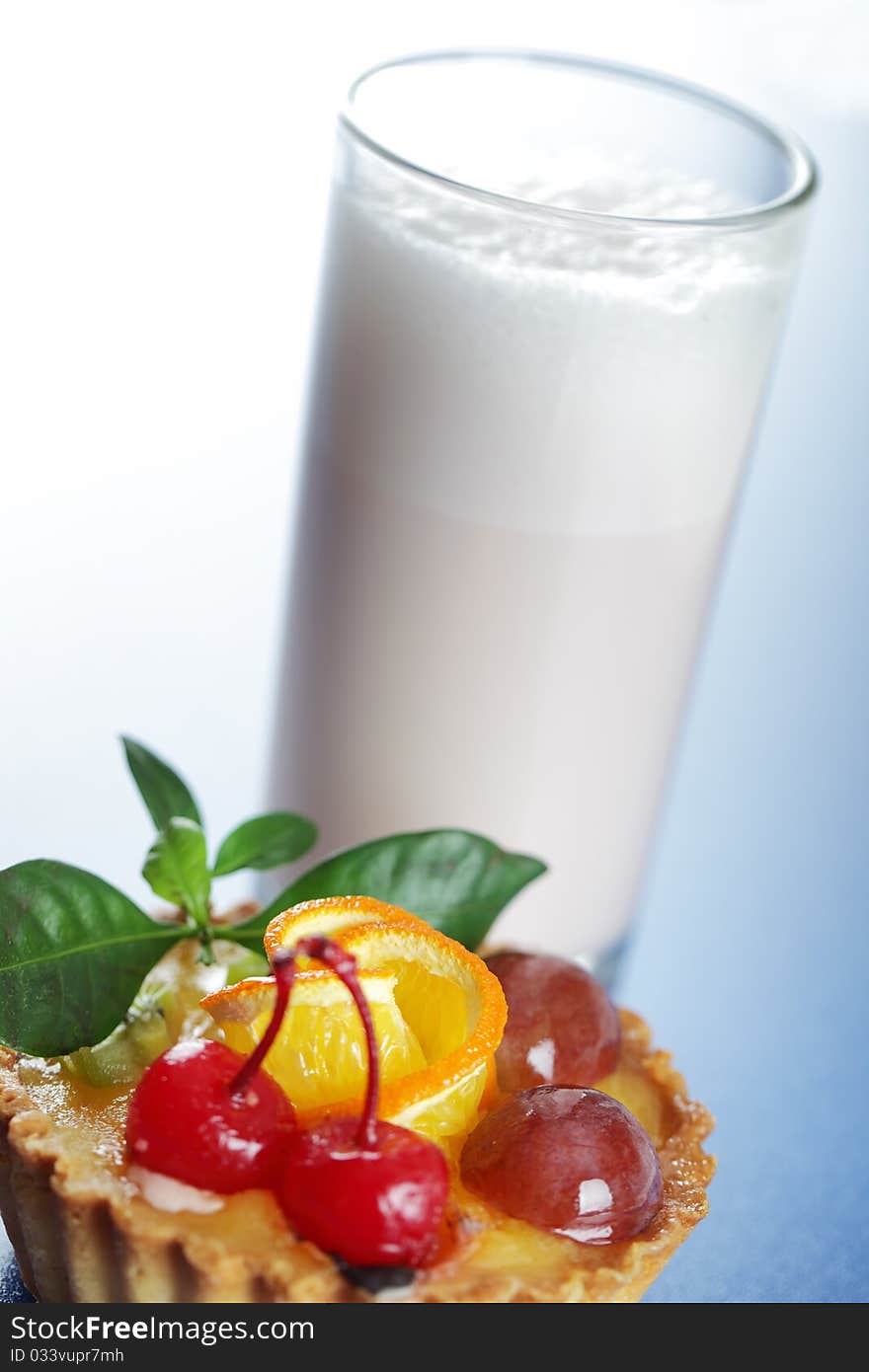 Milkshake and cake on a blue background. Milkshake and cake on a blue background