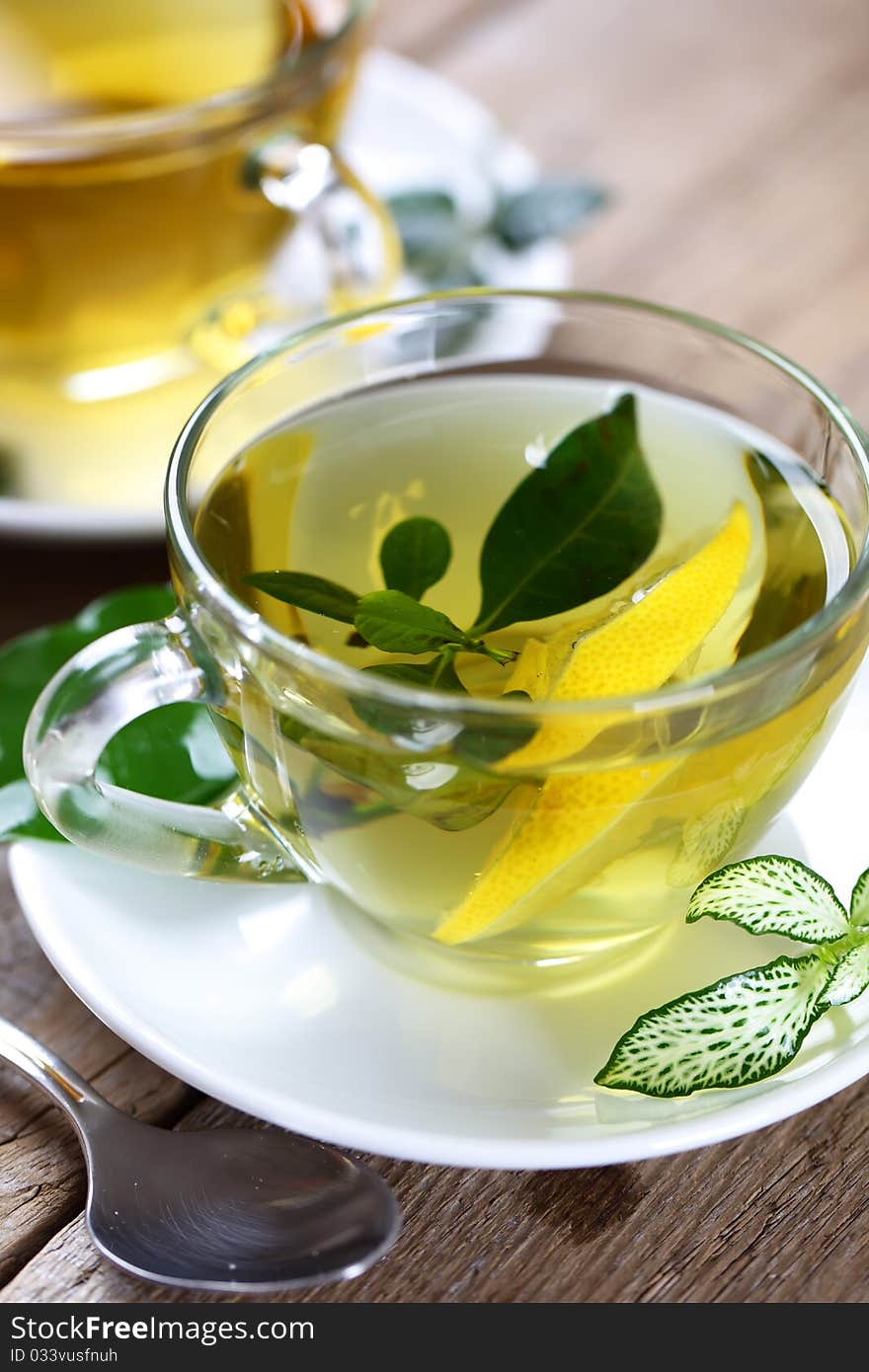 Green tea in a transparent cup with leaf