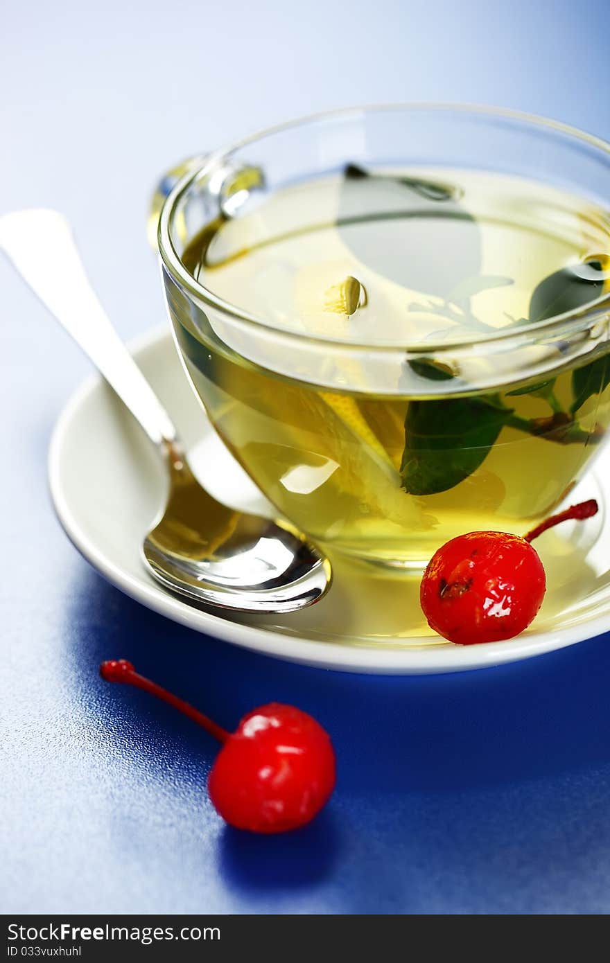 Green tea in a transparent cup with leaf