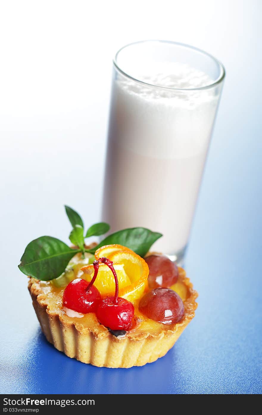 Milkshake and cake on a blue background. Milkshake and cake on a blue background