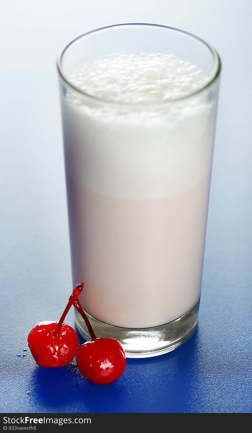 Chocolate milkshake drink in tall glass with chocolate chunks to the side