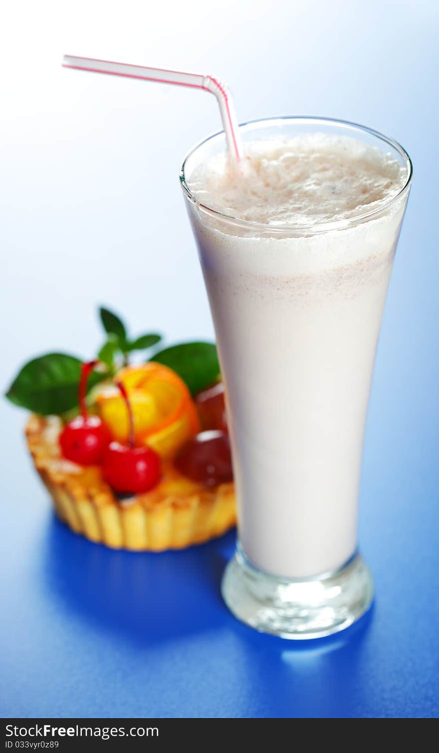 Milkshake and cake on a blue background. Milkshake and cake on a blue background