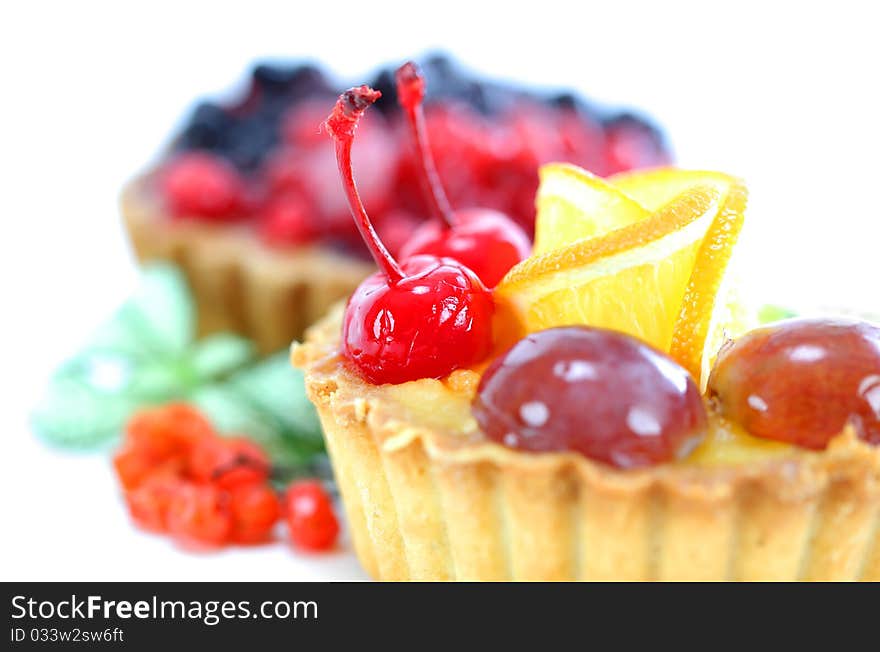 Cupcake with jelly and fruits over white