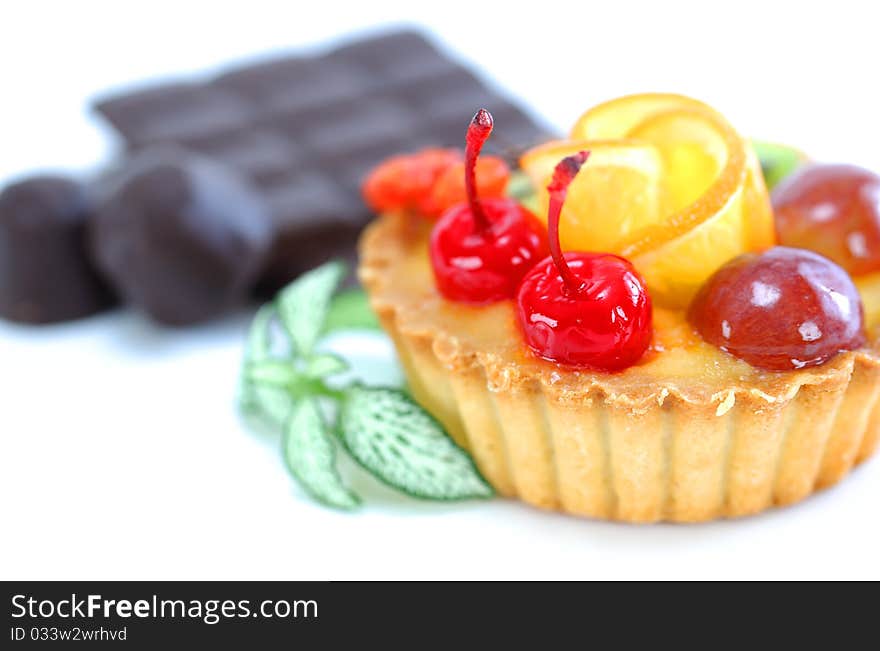 Cupcake with jelly and fruits over white