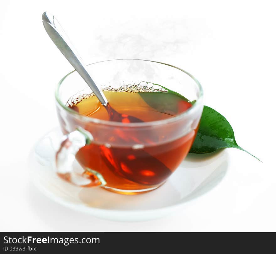 Tea in a transparent cup with leaf