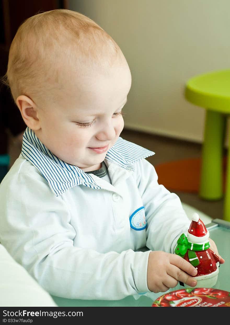 Young child playing with a Santa Claus toy