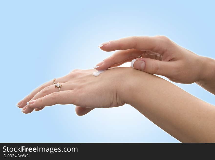 Beautiful woman's hand on blue. Beautiful woman's hand on blue