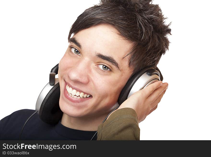 Teenager with headphones listens to music and smiles happy. Isolated on white background. Teenager with headphones listens to music and smiles happy. Isolated on white background.