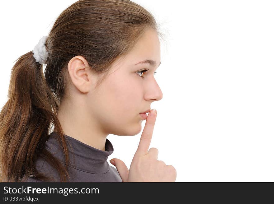 Young woman with finger on lips over white background