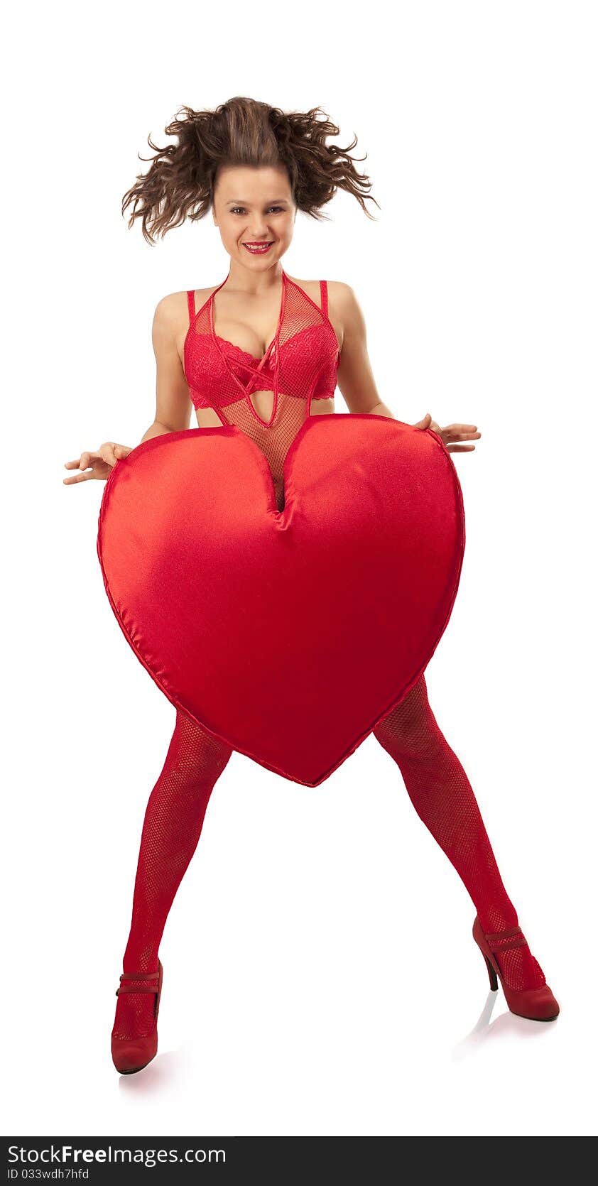 Young woman in red lingerie holding big Heart over white. Young woman in red lingerie holding big Heart over white