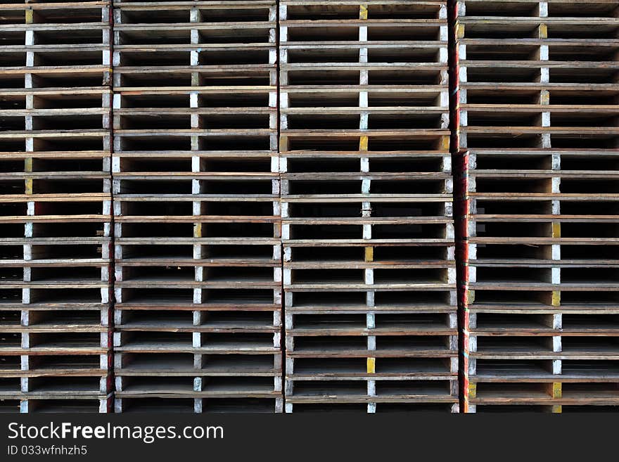 Wooden pallets stacked outside a warehouse