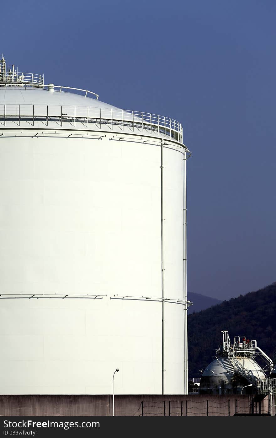 Storage tank with a blue sky background