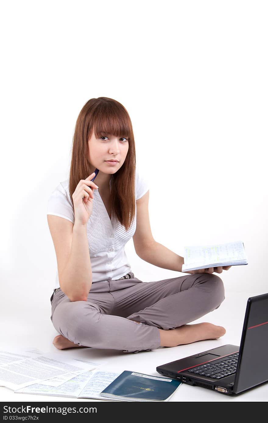 The young girl with the laptop and writing-books. The young girl with the laptop and writing-books