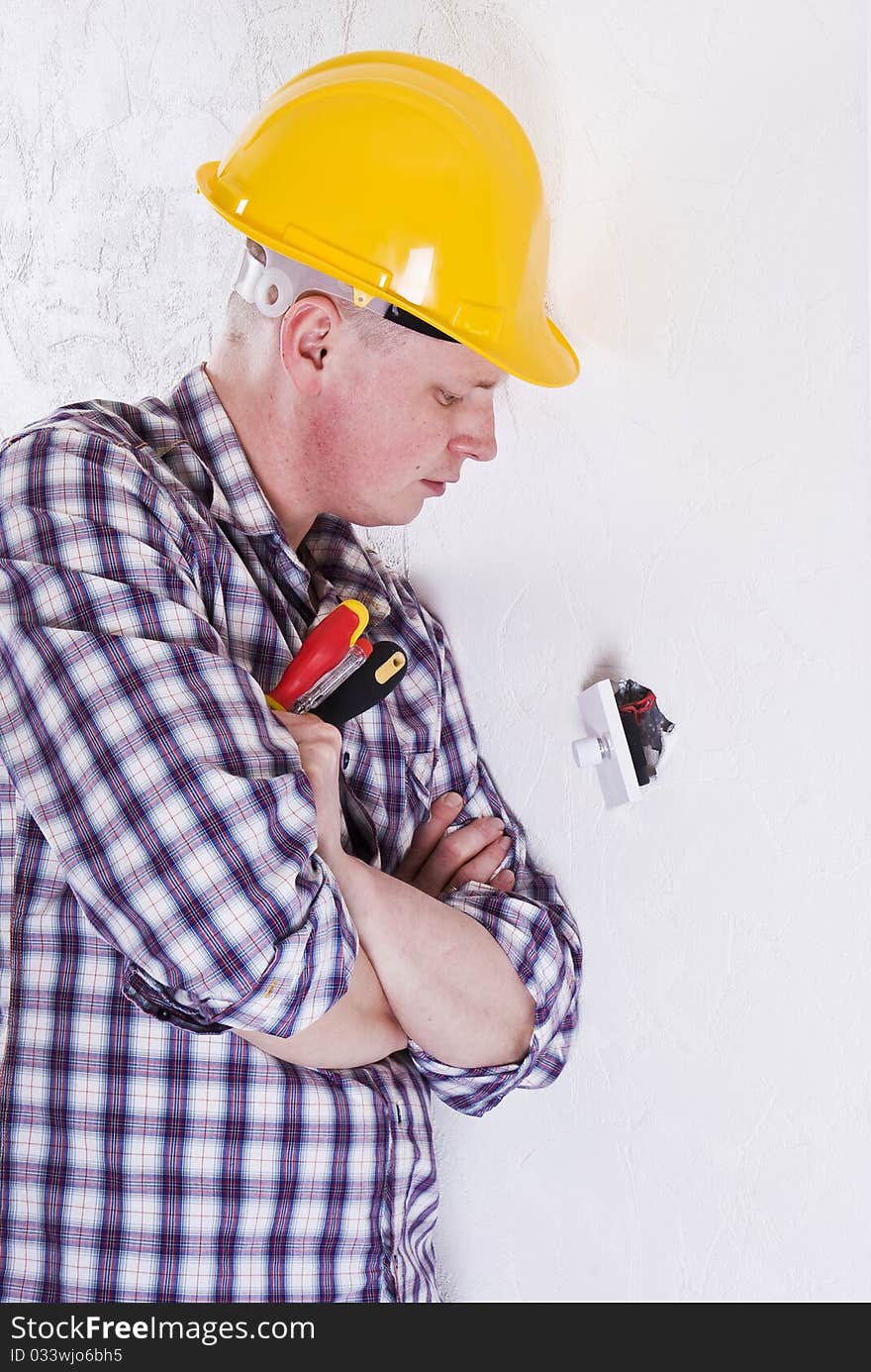 Young Electrician installing new light switch. Young Electrician installing new light switch