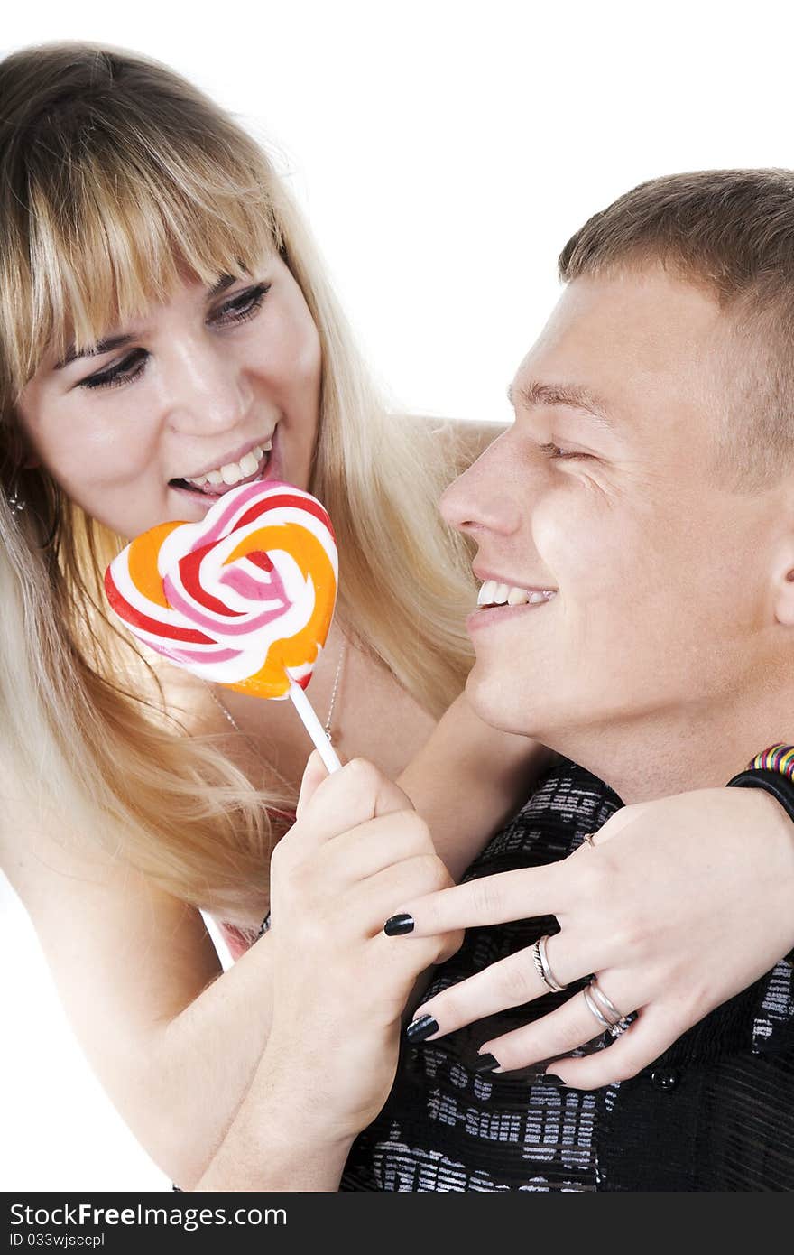 Couple eating lollypop shape of heart