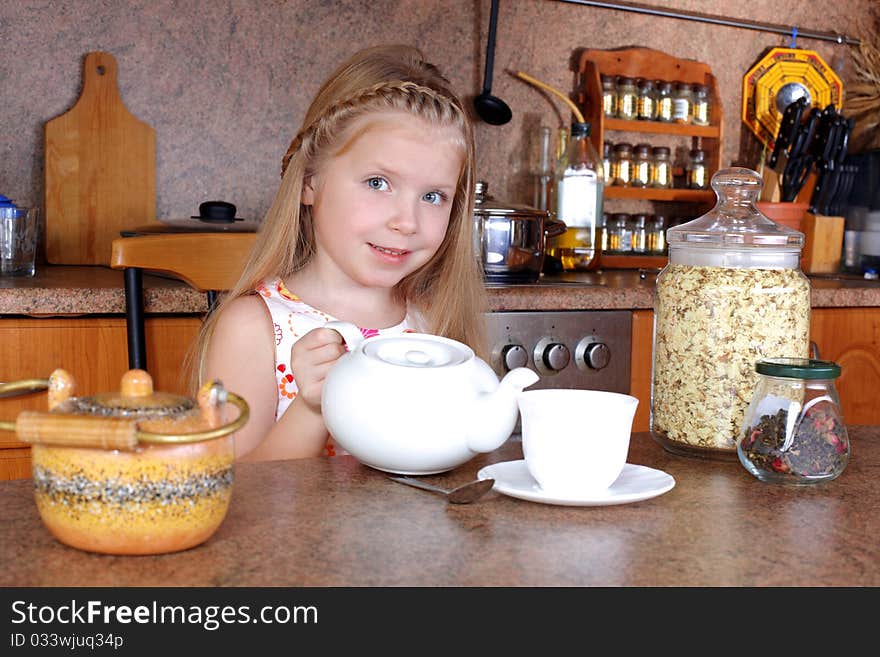 Girl With Teapot And Cup Of Hot Drink