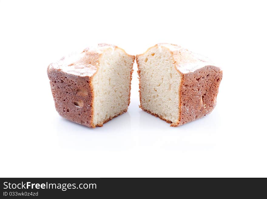 Two pieces of fruitcake isolated on white