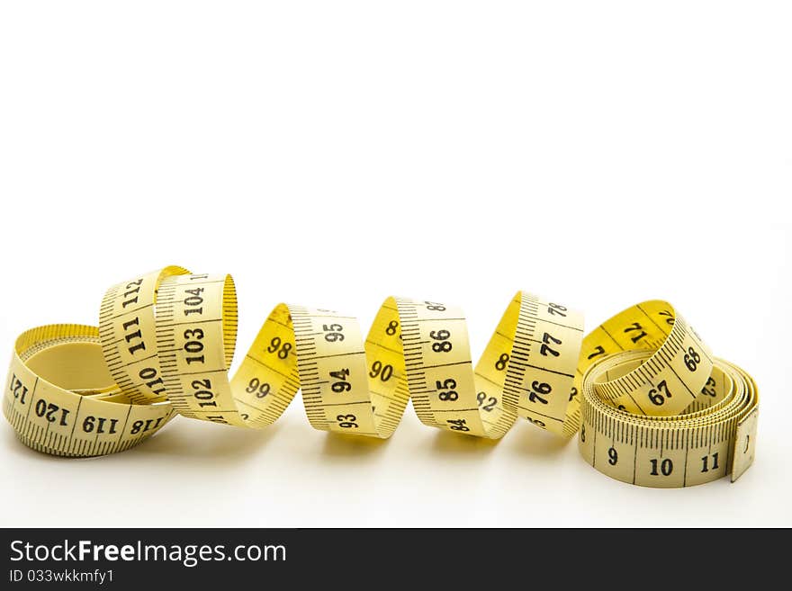 Yellow tape measure onto white background