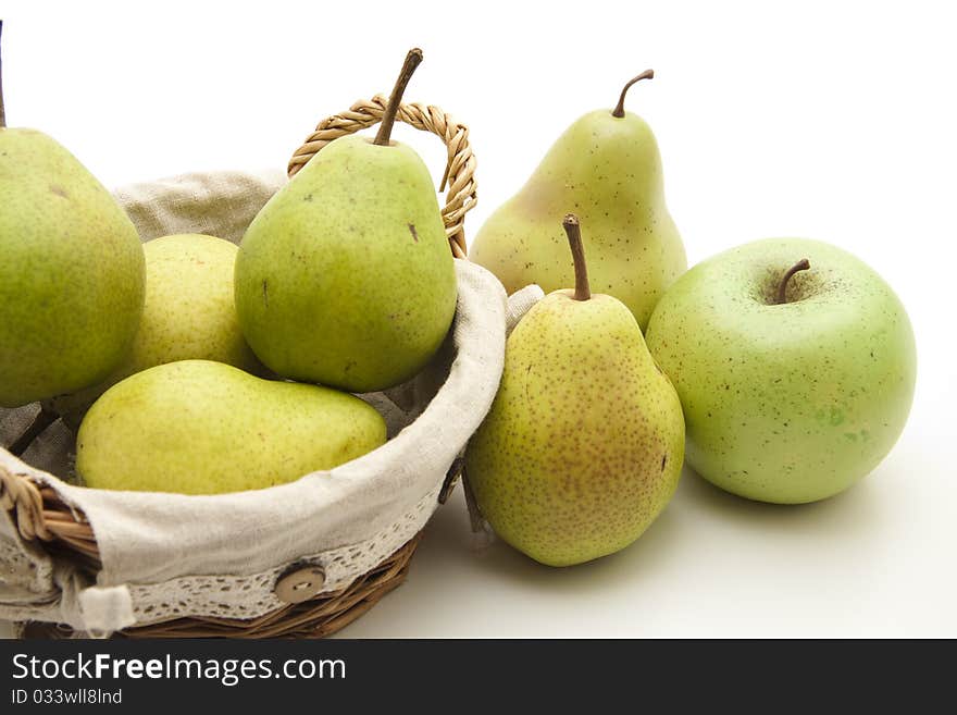 Pears and apple in the woven basket. Pears and apple in the woven basket