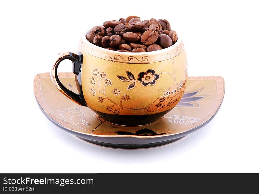 Cup with coffee beans on a plate