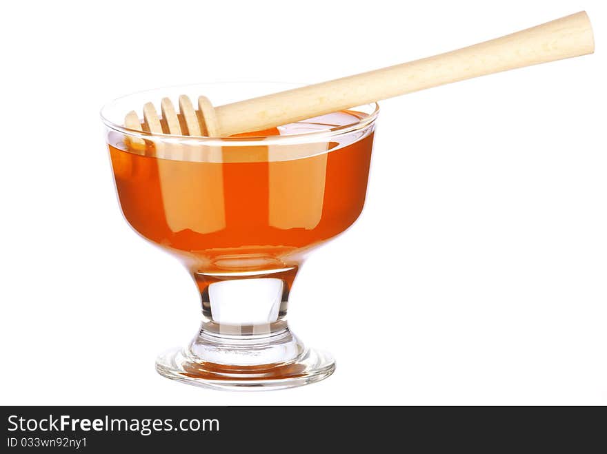 Honey in a glass isolated on white background