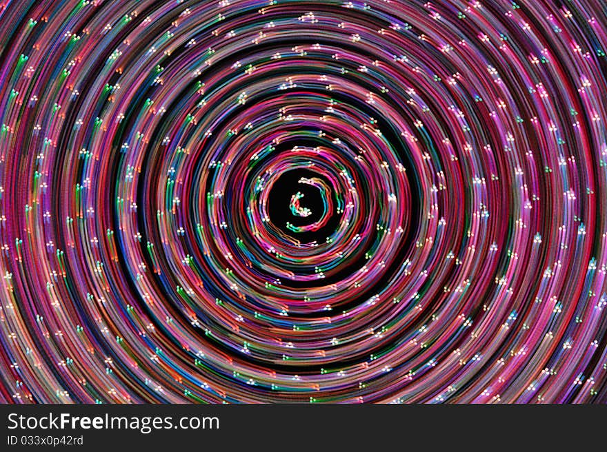 Spinning points of multiple colored lights form abstract image. Spinning points of multiple colored lights form abstract image