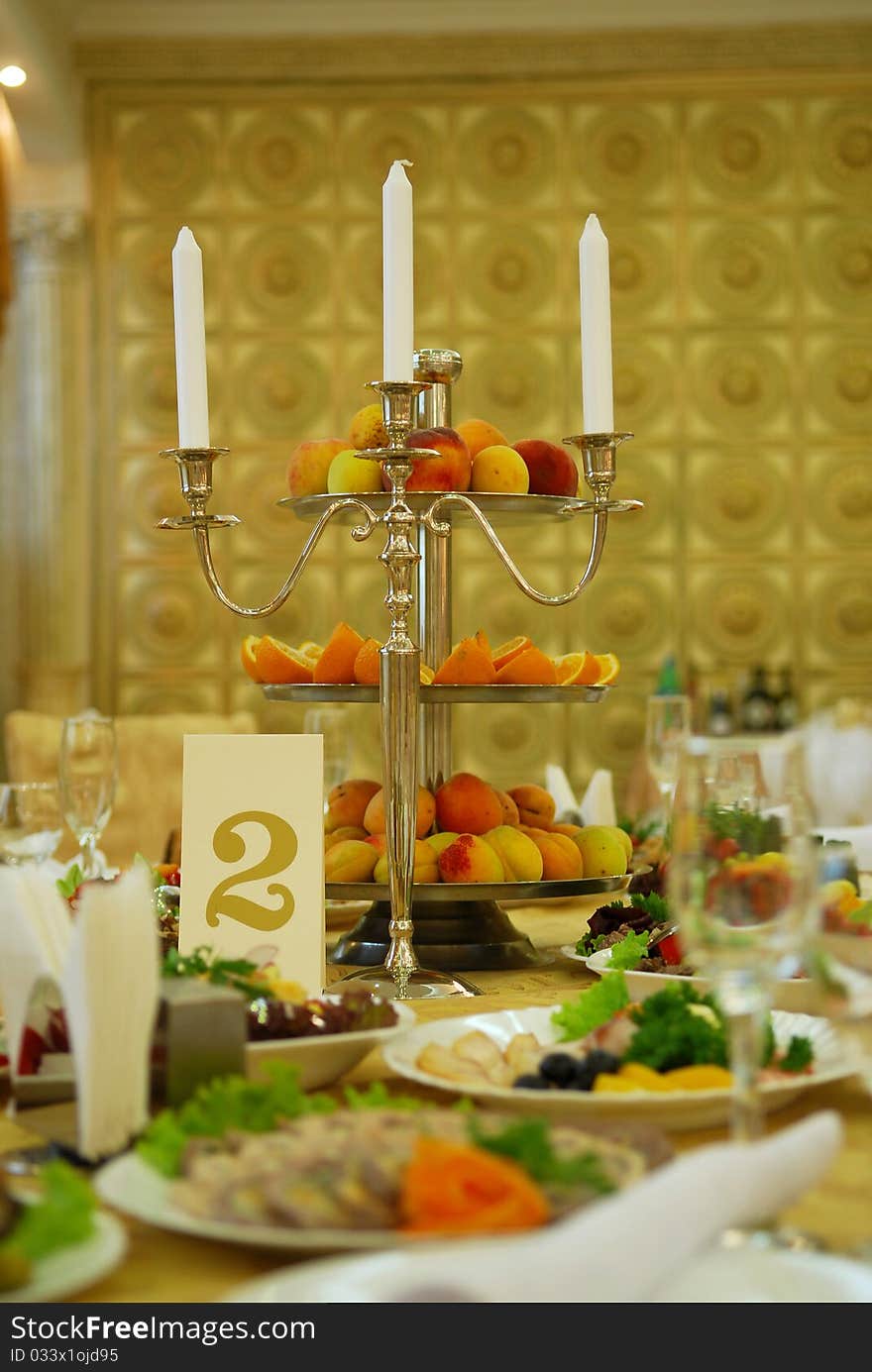 Accent of candlestick and a plate with fruits. Accent of candlestick and a plate with fruits