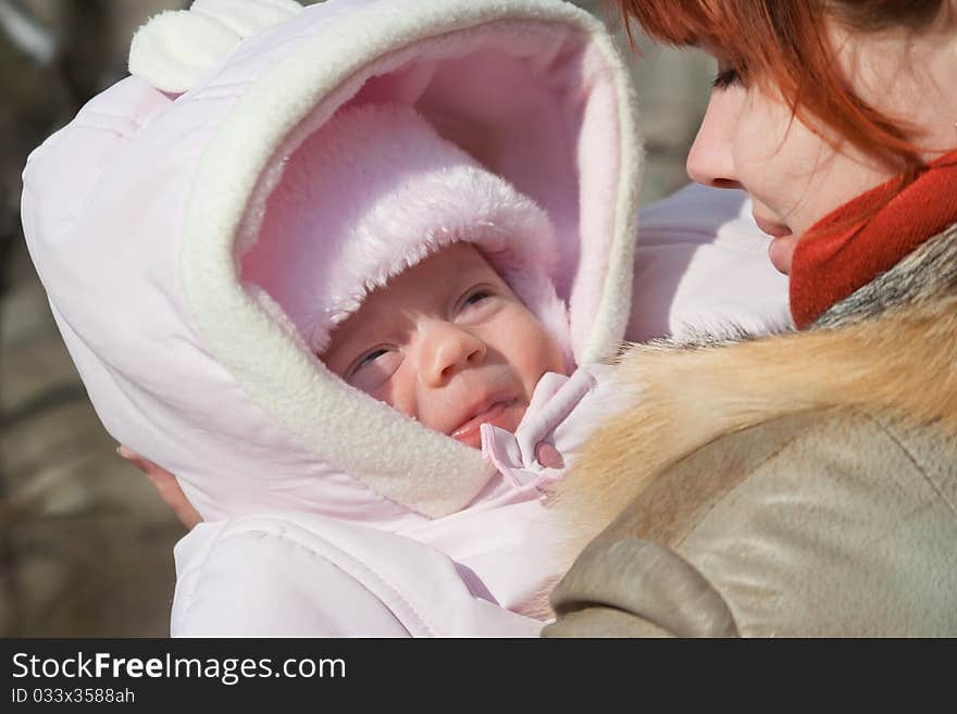 Month baby girl and mother for a walk in a spring sunny day. Month baby girl and mother for a walk in a spring sunny day