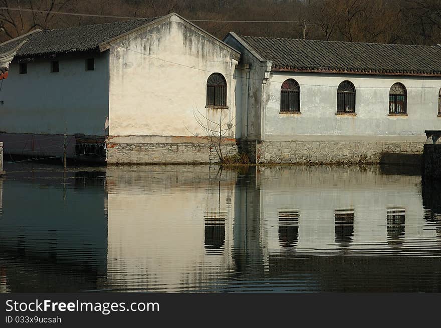 Ancient town house in Wuxi city, China. The reflection of the houses in the river is beautiful. Ancient town house in Wuxi city, China. The reflection of the houses in the river is beautiful.