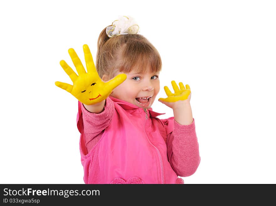 The cheerful girl keeps hands which are painted in yellow color. Isolated over white