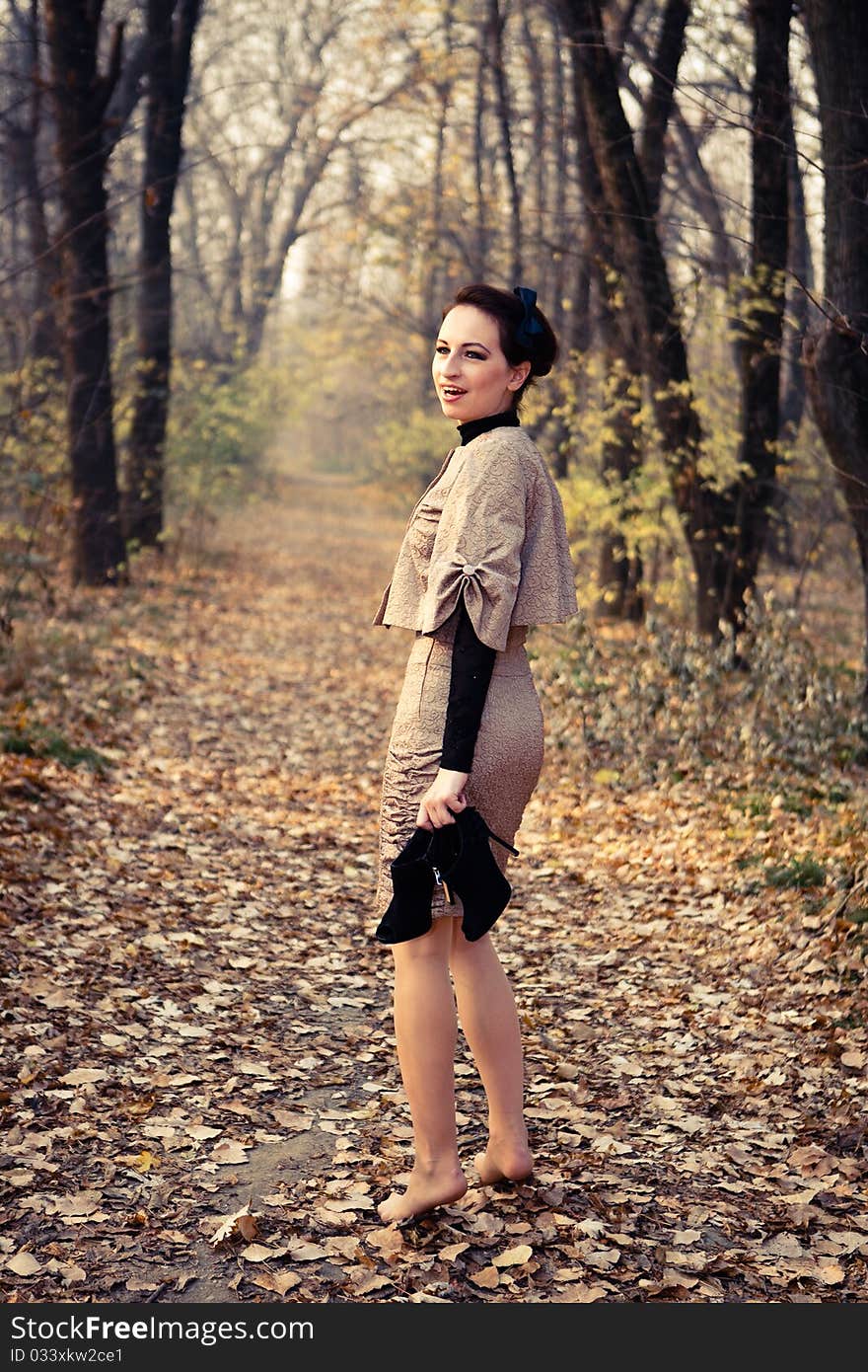 A woman in ancient dress for a walk in the woods