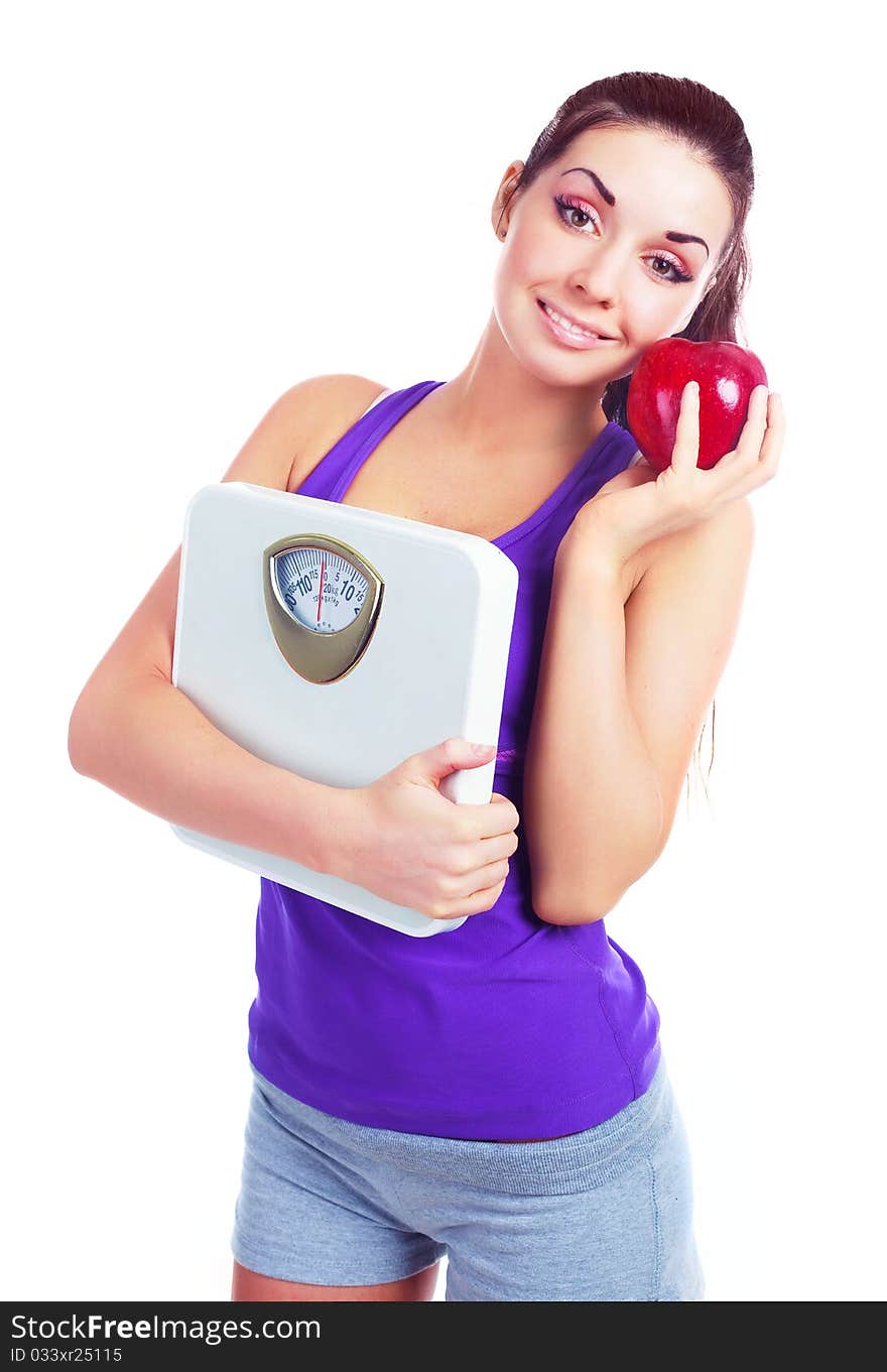 Beautiful young woman  holding scales and a red apple. Beautiful young woman  holding scales and a red apple