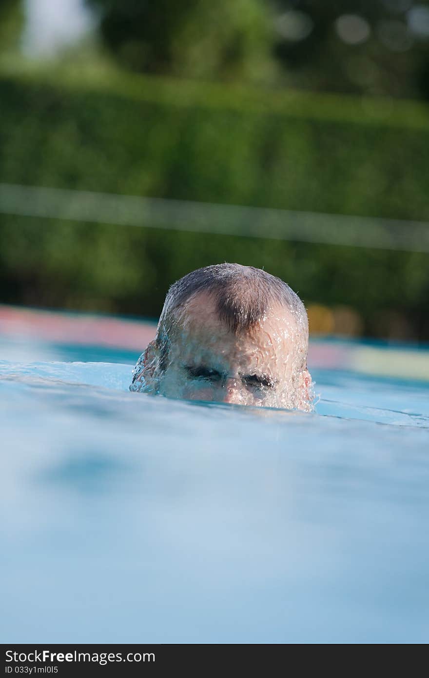 Man swimming in pool. Swim training