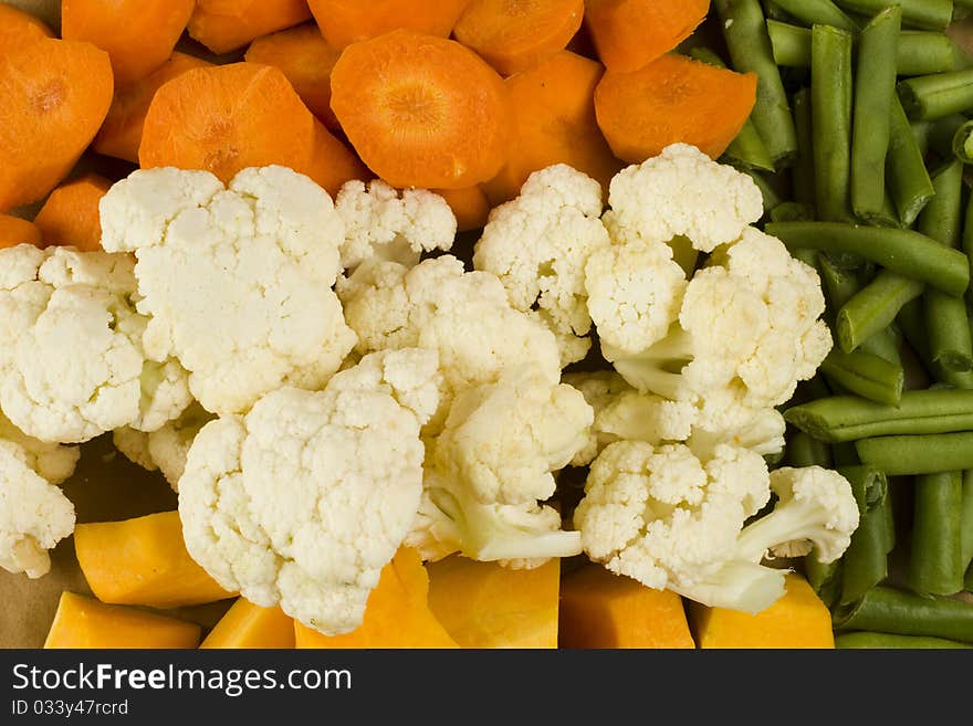 Mixed raw uncooked green beans, collyflower, pumpkin and carrots. Mixed raw uncooked green beans, collyflower, pumpkin and carrots