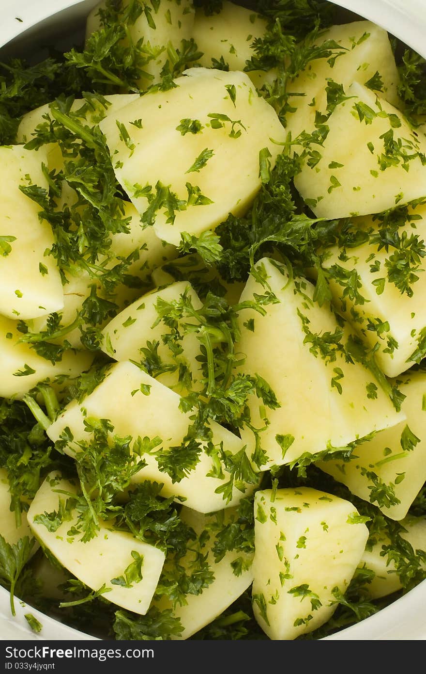 Raw potato cuts in a white bowl