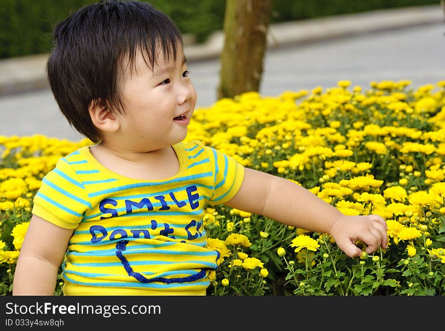 A happy baby is playing in garden