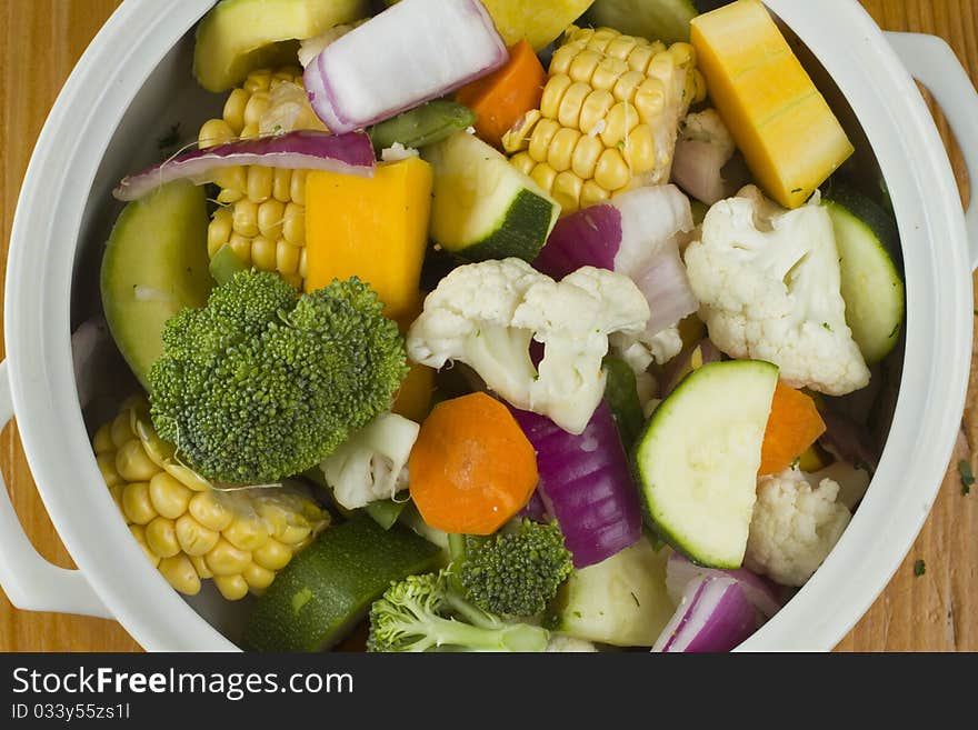 Sweetcorn, pumpkin, collyflower and mixed vegetables in a white bowl