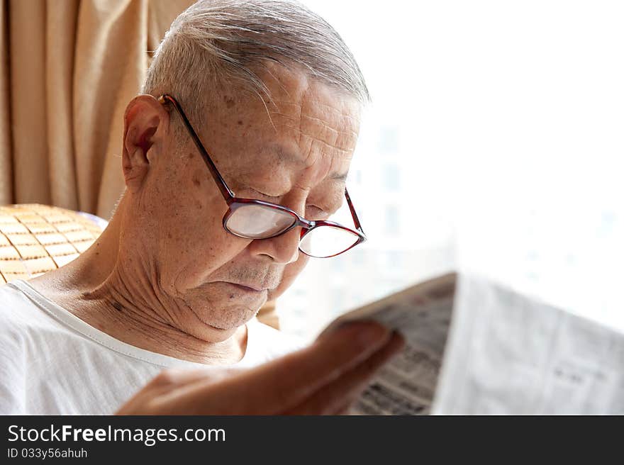 A senior man is reading