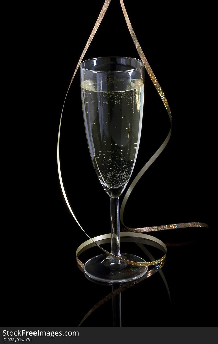 Glass with champagne and paper streamer. Glass with champagne and paper streamer