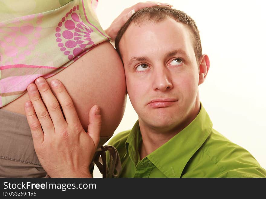 Father listening to his wife's stomack. Father listening to his wife's stomack