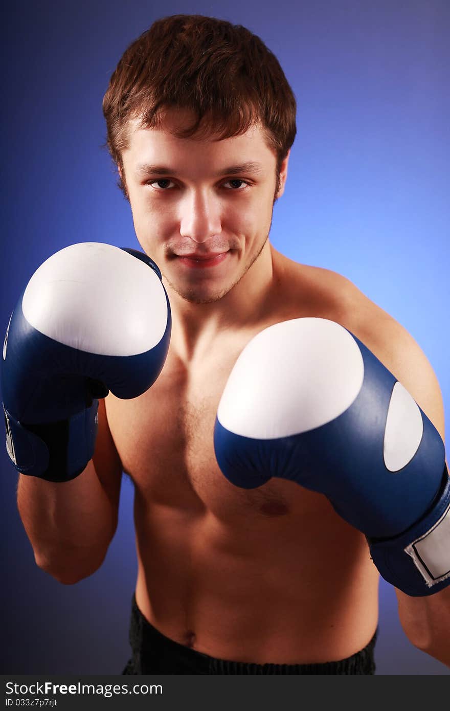 Young handsome boxer on blue background. Young handsome boxer on blue background