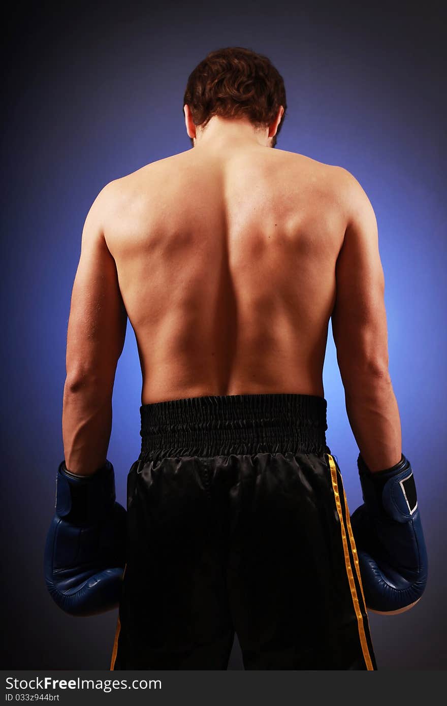 Young boxer standing in studio. Young boxer standing in studio