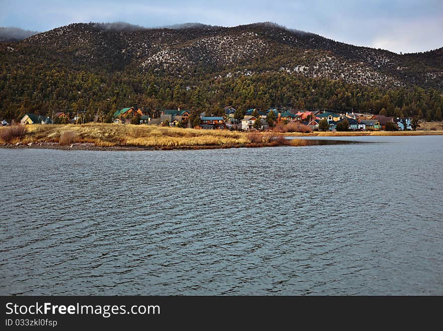 A view of lakefront homes during a cold, sunny day in the mountains. A view of lakefront homes during a cold, sunny day in the mountains.