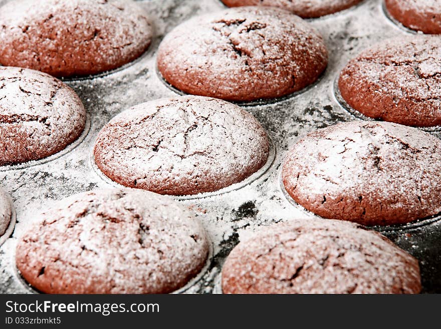 Chocolate muffins in baking tray - detail / closeup