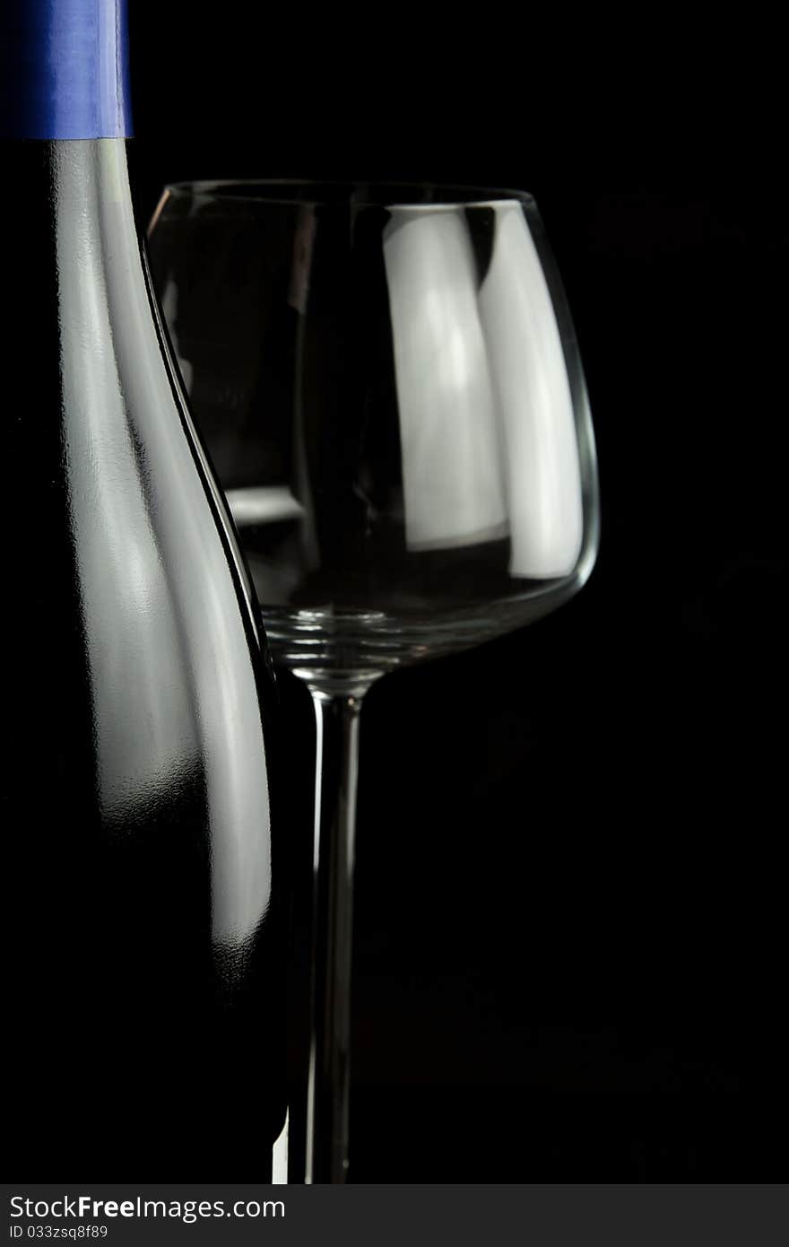 Wine glasses and wine bottle isolated over black background. Wine glasses and wine bottle isolated over black background