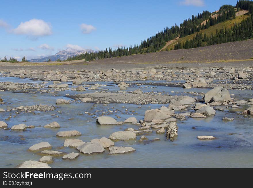 Creek in Coast mountains with Whistler Mountain in the background. Creek in Coast mountains with Whistler Mountain in the background