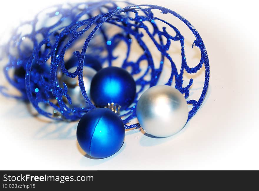 Close-up blue curling ribbon with Christmas-tree decorations