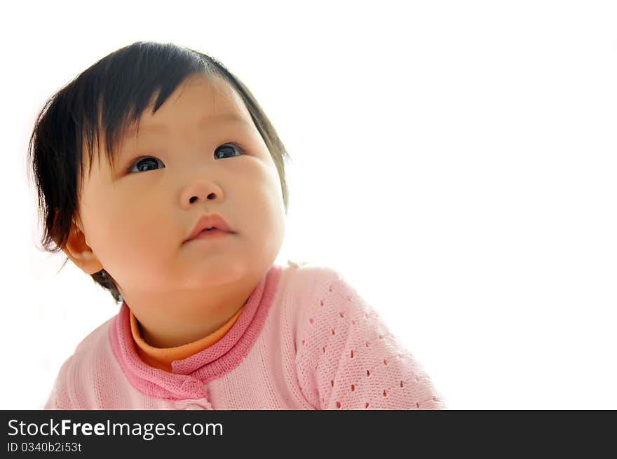 A Asian baby girl sitting on the bed