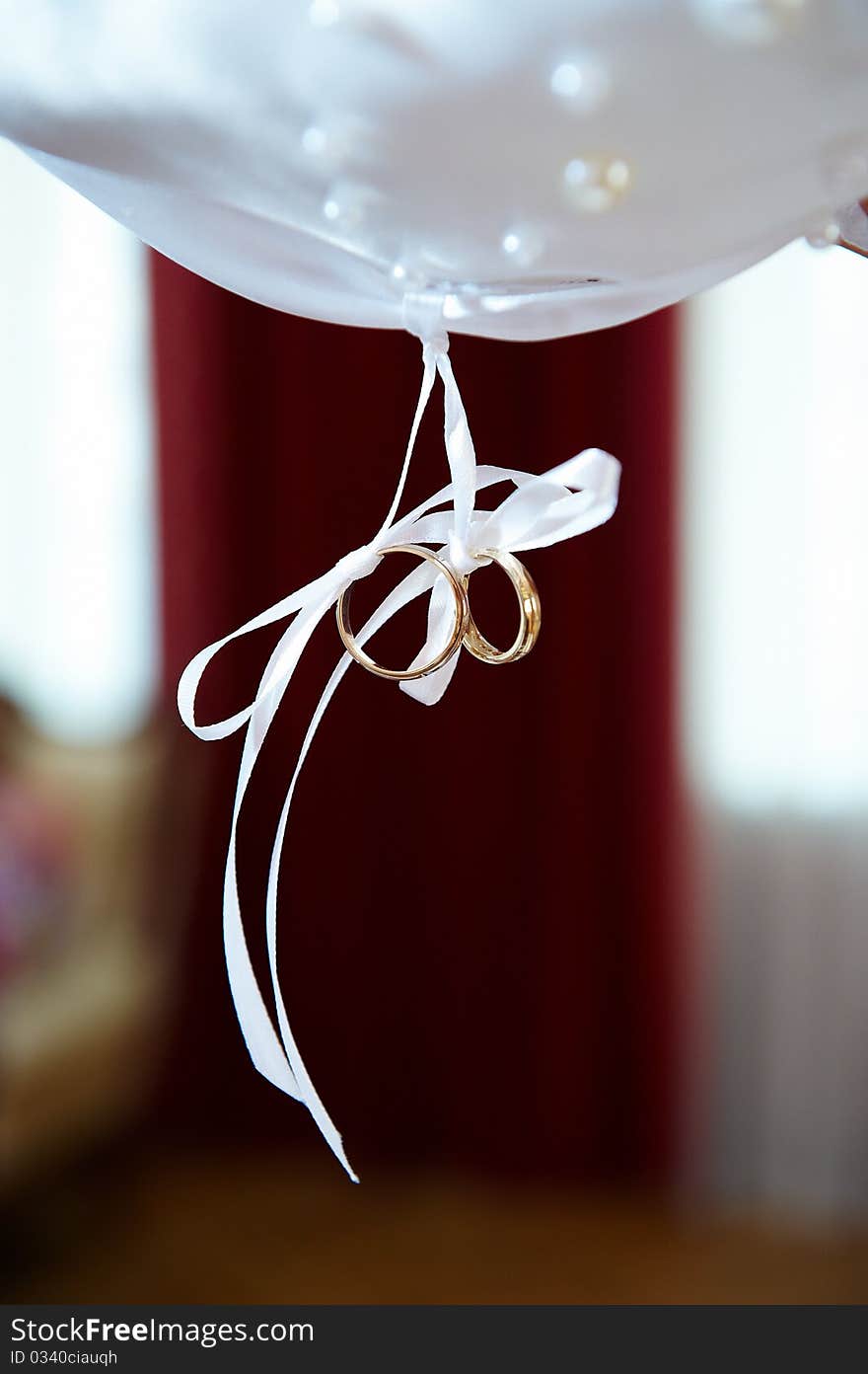 Wedding gold rings on white ribbons as a symbol of good marriage