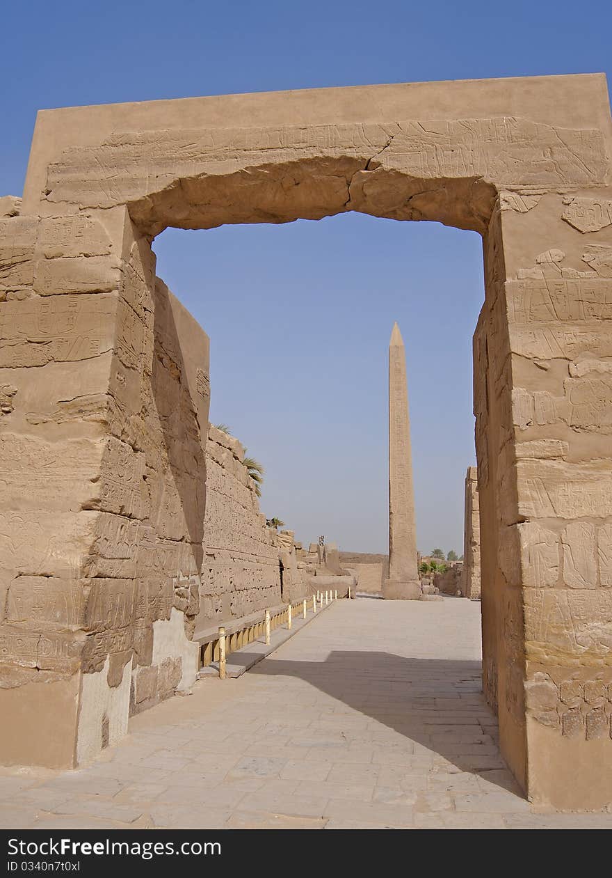 View of one of the obelisks at Karnak temple in Luxor through an archway. View of one of the obelisks at Karnak temple in Luxor through an archway